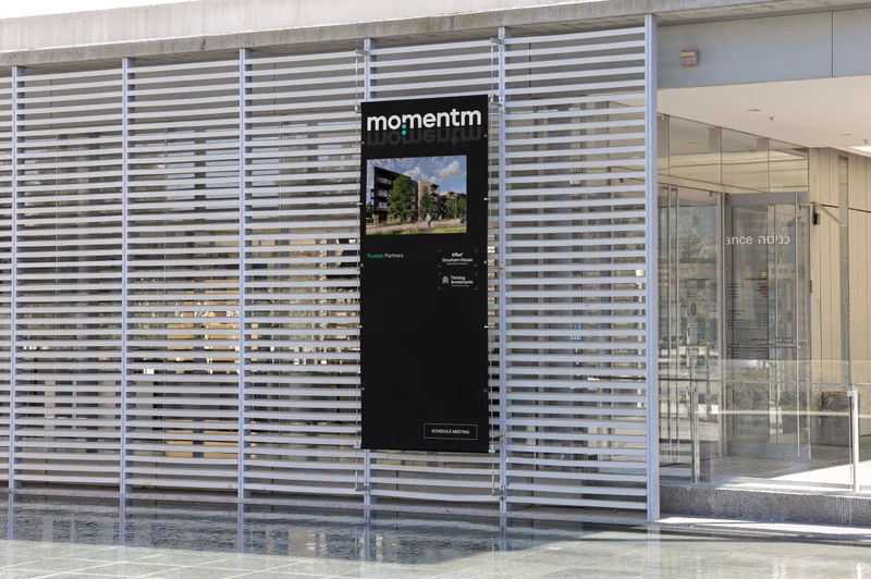 A Momentm banner on a slatted building facade