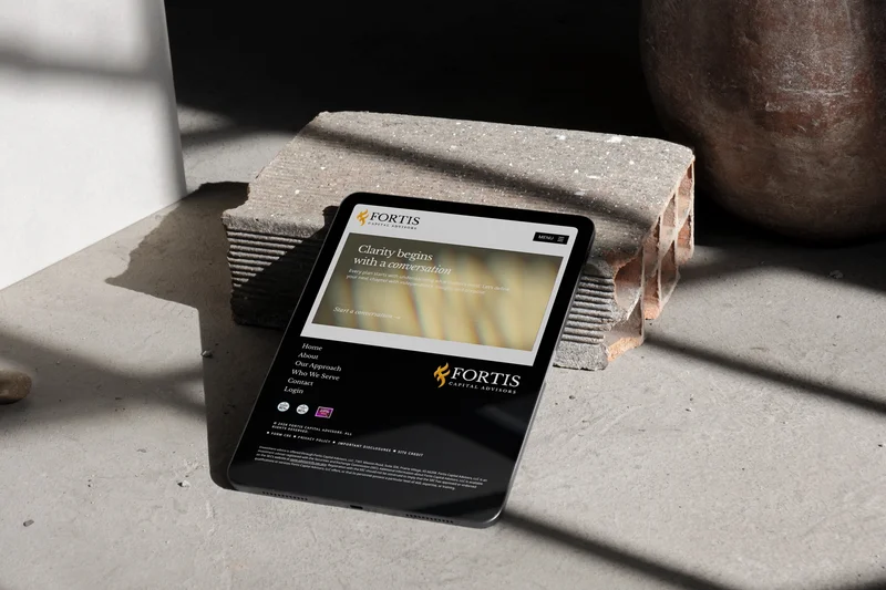 The Fortis Capital footer on a tablet, resting on a brick