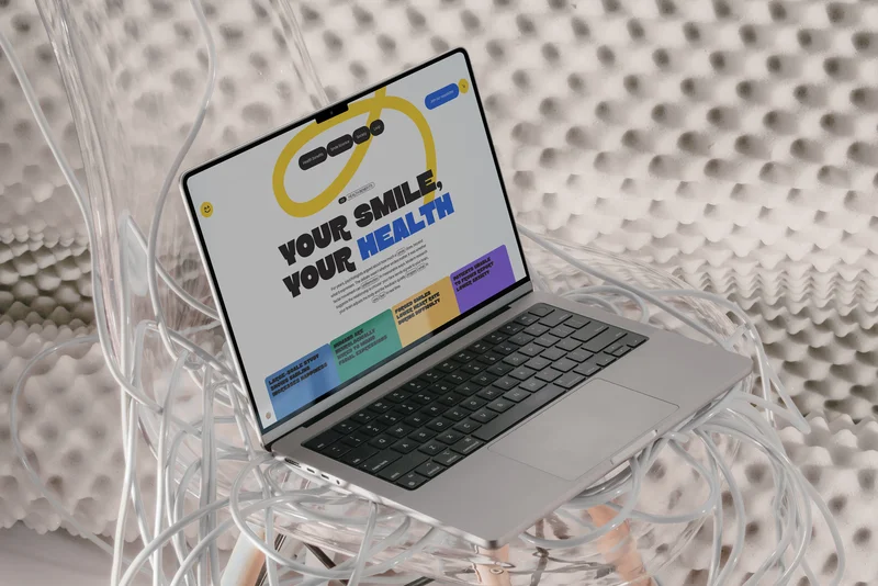 The Inaam website on a laptop on a transparent chair