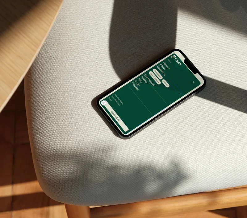 The Fisar mobile menu open on a phone, resting on a chair