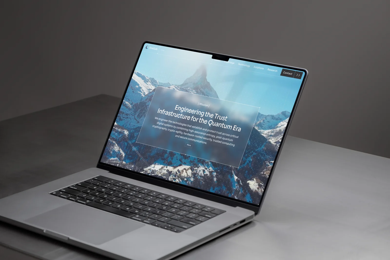 The EnsoLab homepage on a laptop, a mountain range behind the headline